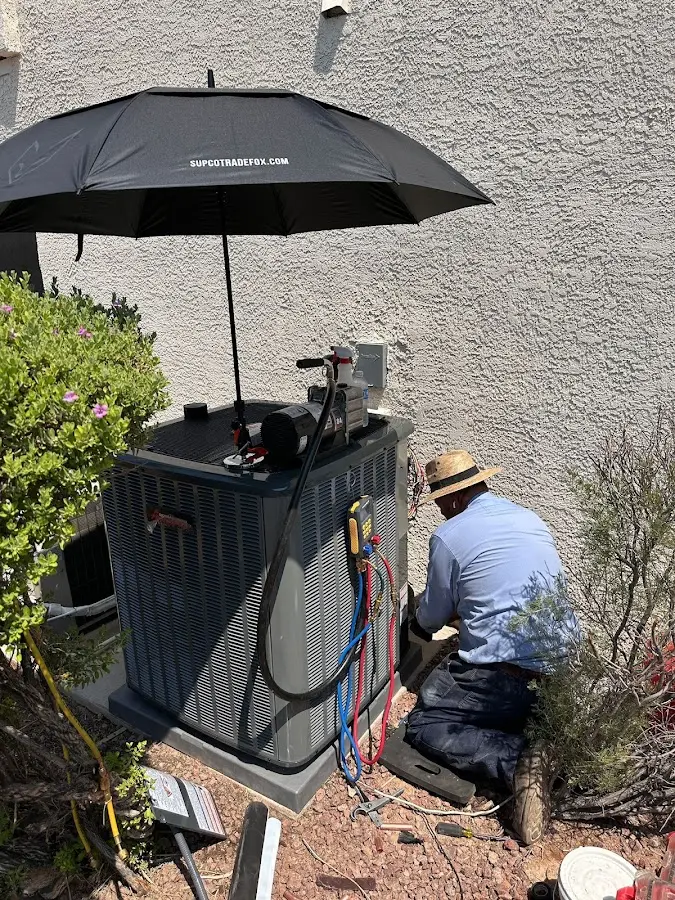 HVAC technician performing outdoor AC maintenance in Christiansburg